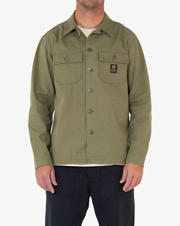 khaki regular fit military overshirt with chest flap pockets and branded label, 100% cotton herringbone fabrication with heavy enzyme stonewash